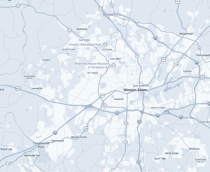 A grayscale map showing Winston-Salem, North Carolina, and surrounding areas, including highways, parks, and landmarks such as Reynolda House Museum of American Art and Historic Bethabara Park.