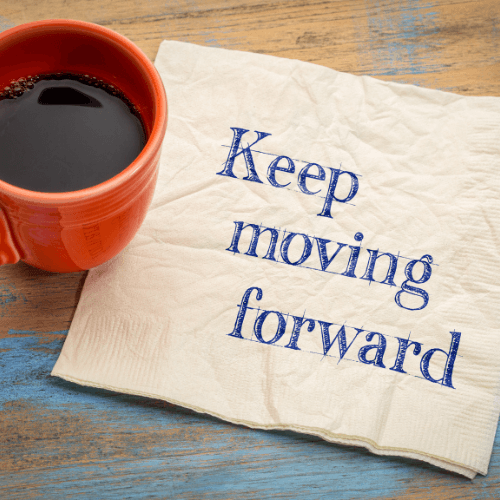 keep moving forward on napking with cup of coffee