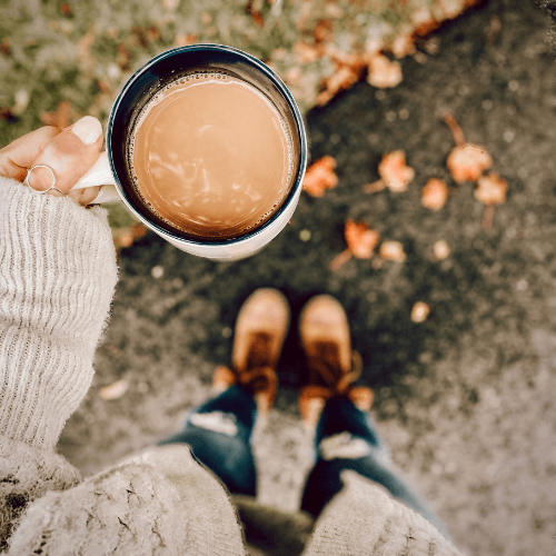 woman outside with coffee in boots and sweater, organize for seasonal change, Organized Jill, Winston Salem NC